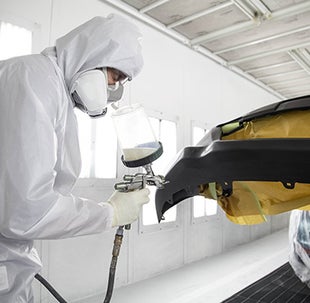 Collision Center Technician Painting a Vehicle | Arlington Toyota in Palatine IL