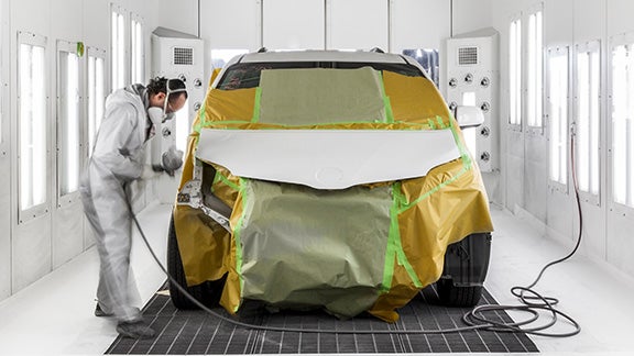 Collision Center Technician Painting a Vehicle | Arlington Toyota in Palatine IL